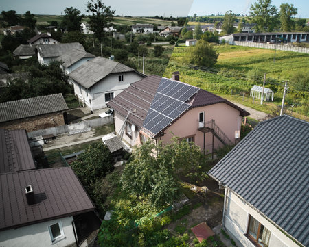 Collage of photos of installation and ready solar panels on the roof of house. Before and after concept. Modern technology and innovation. Idea of environment safety. Aerial view.の写真素材