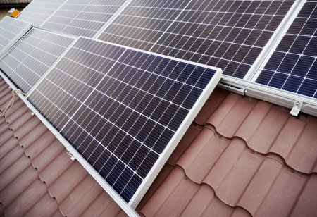 Close up view of solar photovoltaic panel system on house roof.の写真素材