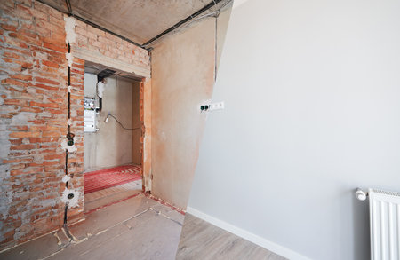 Photo collage of apartment room before and after restoration or refurbishment. Old room with doorway and new renovated living room with parquet floor and elegant interior design.の写真素材