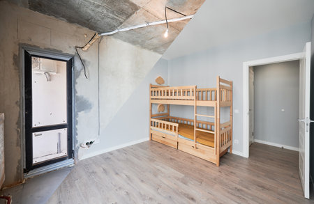 Comparison of children room with wooden bunk bed before and after restoration. Old apartment room with brick wall and new renovated flat with parquet floor and kid house bed.の写真素材