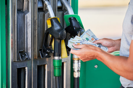 Cropped view of man shocked how much gasoline costs. Driver counting if he has enough money to pay for fuel. Transportation expenses concept.の写真素材