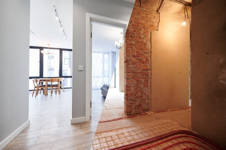 Living room and bedroom with large windows and doors before and after refurbishment or restoration. Old apartment before renovation and new renovated flat with parquet floor and furniture.の写真素材