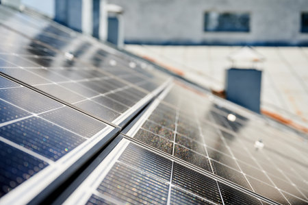 Solar photovoltaic panels on rooftop. Close up of solar batteries installed on top of modern house. Concept of alternative energy sources in modern life.の写真素材