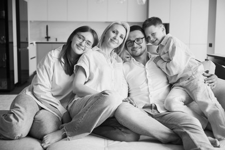 Lovely portrait of family chilling together at home. Big family lying on couch and hugging. Cute...