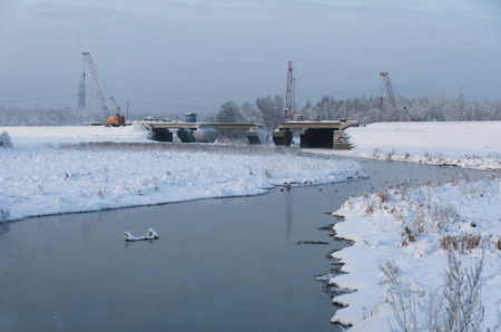 Building the bridge in winterの写真素材