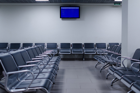Waiting zone in an airport with chairs and timetable.  Airport Pulkovo, Russia.の写真素材