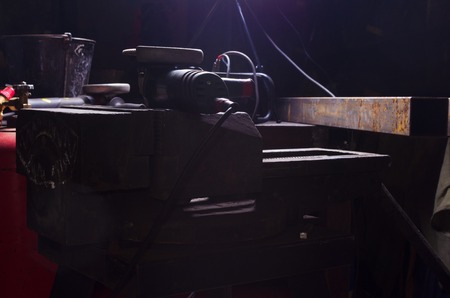 Hand tools in forge with background light.の写真素材