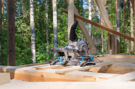 miter saw in building area. tools in wooden house. building ecological houseの写真素材