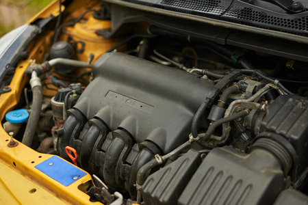 Close up engine in yellow car. Car service.