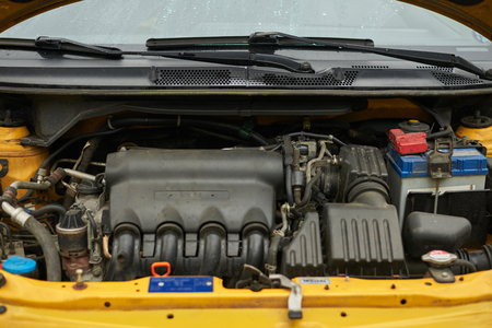 Close up engine in yellow car. Car service.の写真素材