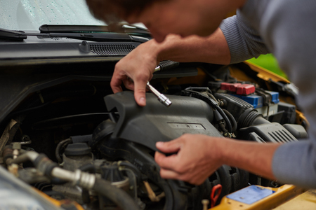 Open engine cap. Mechanic start repair yellow car.の写真素材