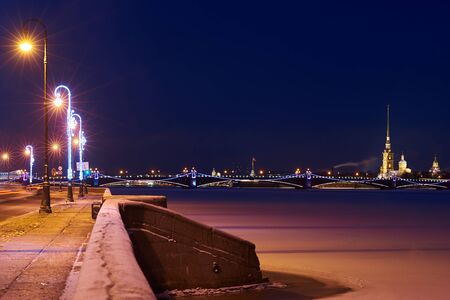 Perfict view on ice Neva river, Kutuzov enbankment and St.Peter and Paul fortress in night winter time. Copy space for a text.の写真素材
