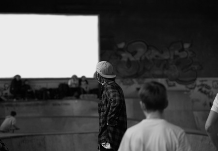Extreme games concept. Skatepark with skatebarders, BMX riders, kick scooters. Blank space on the wall. Wooden park under roof for ride in winter time.の写真素材