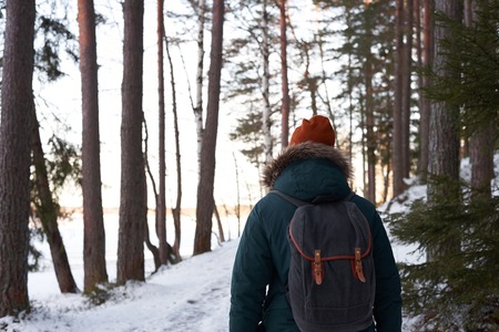 Strong and brave guy travel alone countryside. Man go through the forest with backpack. Ecological trip with fresh air. Healthy walking away of big and dirty city.の写真素材