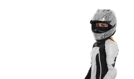 Woman motorcyclist portrait on white background. Girl in motocycle helmet in motorbike suite. Motor life concept. Portrait of extreme femail. Free space for advertising biker goods.の写真素材