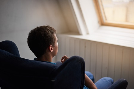 Man in chair in front of window. Thinking and dreaming person. Relax time after lunch. Rest in village house.の写真素材