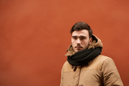 Waist up shot of attractive confident young European male with beard and mustache dressed in winter clothes, staring at camera with serious look. People, lifestyle, seasons and clothing conceptの写真素材