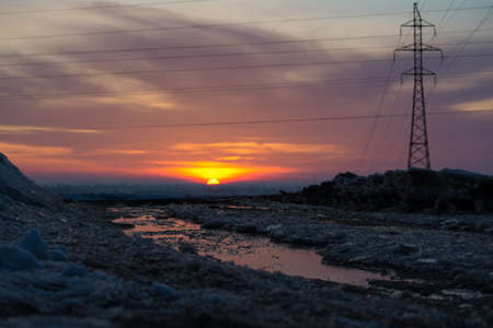 View of winter landscape with frozen lake on the background of a sunset.の写真素材