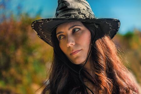 The girl's portrait in a cowboy's hat on outdoorの写真素材