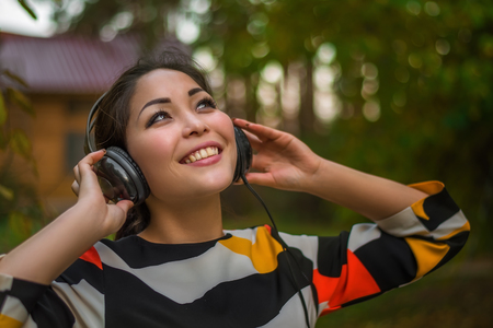 Young beautiful girl listens to music and dancesの写真素材