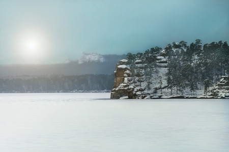 A small rocky island in the frozen winter Baikal Lakeの写真素材