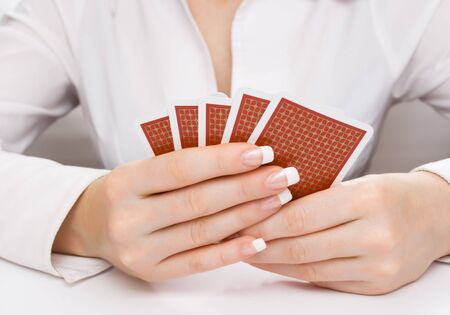Woman's hands holding five playing cardsのeditorial素材