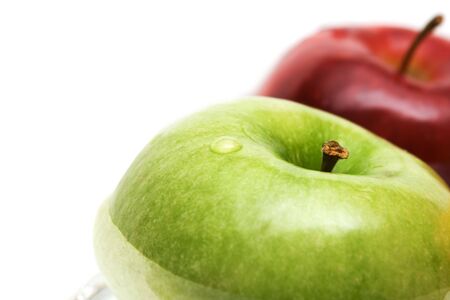 Green and red apples in water, isolated
