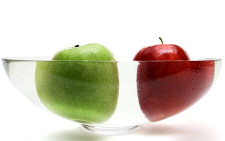 Green and red apples in vase with water, isolatedの写真素材