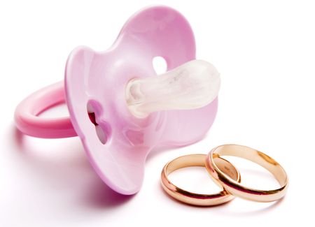  pacifier and wedding rings, concept of having  after marriage, isolated, with clipping pathの写真素材