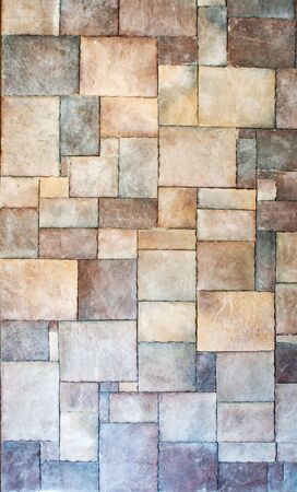 Wall made of multicolored bricks of different sizeの写真素材