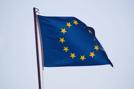 European Union flag across the blue skyの写真素材