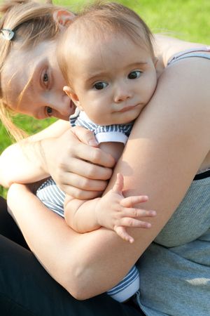 Mother embracing baby in the park