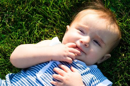 Portrait of a baby lying on the grass