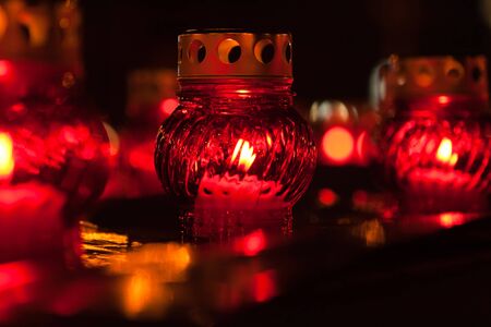 Red candle lights on dark backgroundの写真素材