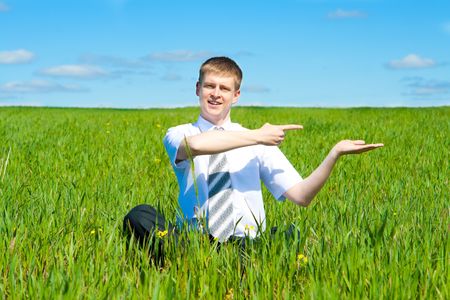Man sitting in the green fieldの写真素材