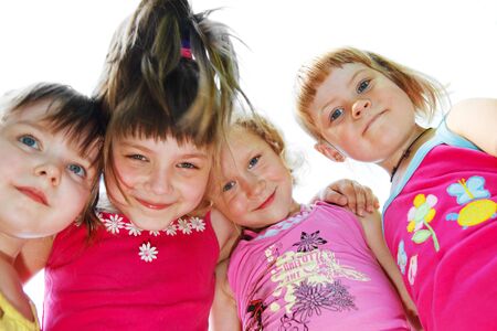 Portrait of  the four happy friends hugging の写真素材