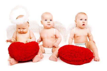 Three angelic baby friends with red heartsの写真素材