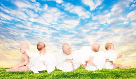 Three baby angels sitting with their backs to the cameraの写真素材