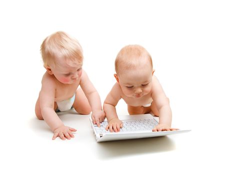 Two modern baby boys with laptop, isolatedの写真素材