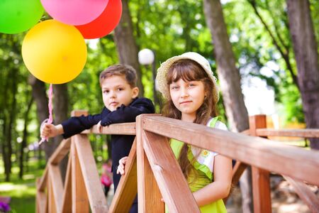 Preschool boy in suit and a lovely girl enjoying time togetherの写真素材