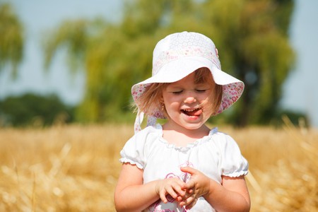 Portrait of a pleased little girl with her mouth outの写真素材