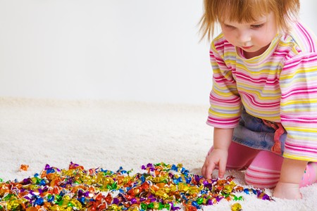 Sweet girl choosing candyの写真素材