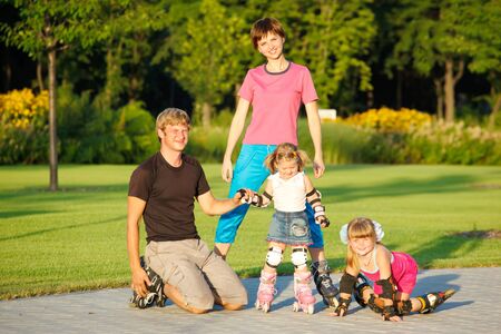 A happy family in roller skatesの写真素材