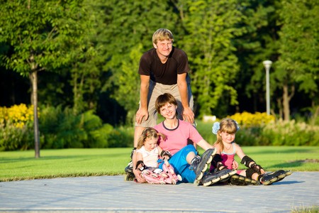 A happy family in roller skatesの写真素材