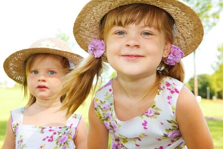 Two sweet kids in straw hatsの写真素材