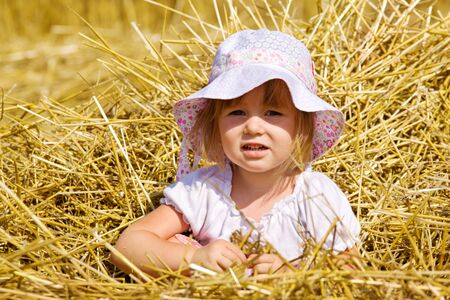 Portrait of a little girl in strawの写真素材