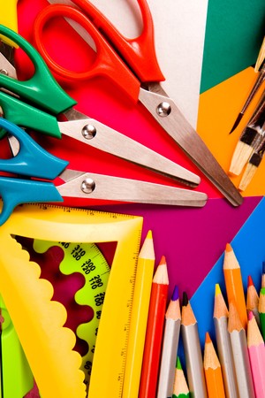 Pecils, scissors, rulers, paintbrushes on cardboard