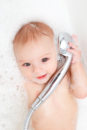 Portrait of a baby  in soap foam