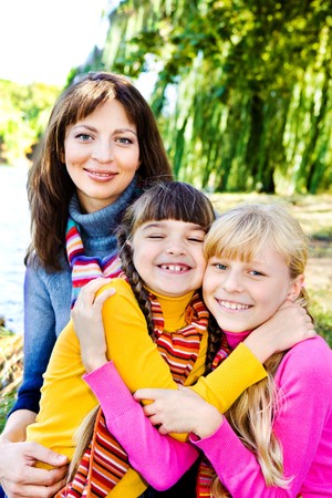 Happy sisters and their mother behind