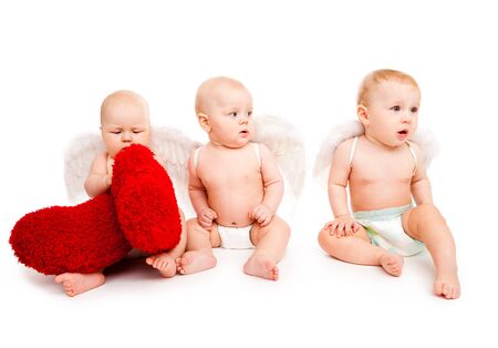 Three baby angels with red heartsの写真素材